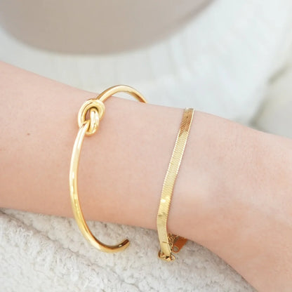 Eternal love gold bangle displayed on wrist 