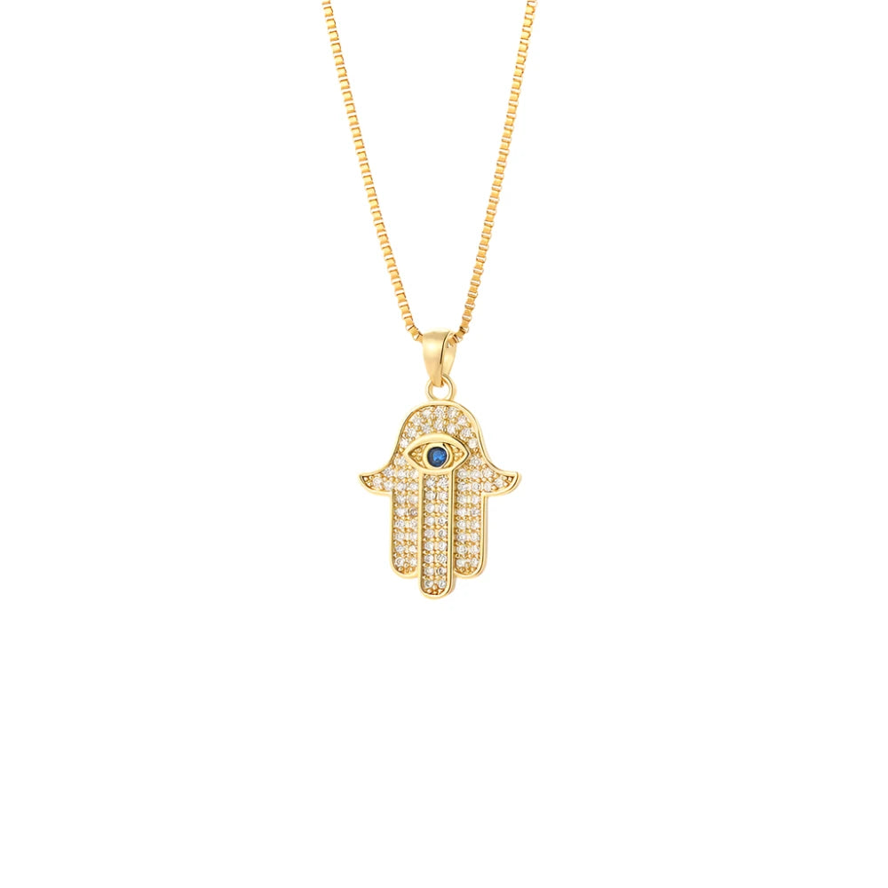 Gold Hamsa Hand Pendant Necklace adorned with sparkling stones and a blue eye.